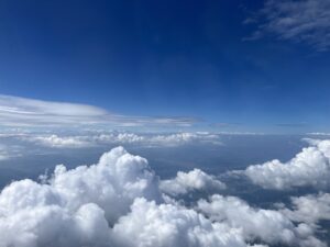 Above the clouds in blue sky