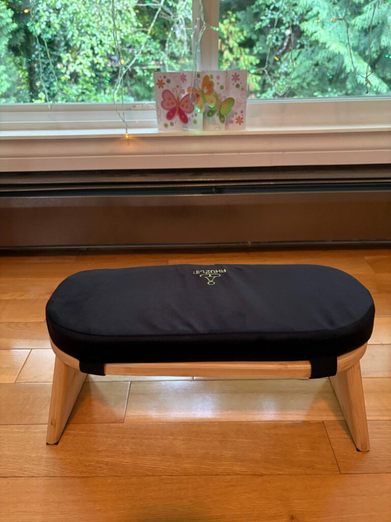 Wooden meditation bench with black cushion